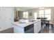 Bright kitchen features white cabinets, stainless steel appliances, granite countertops, and a dishwasher at 259 Johnson Ridge Way, Four Oaks, NC 27524