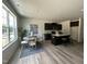 Modern kitchen flows into a dining area with large windows and stylish decor at 259 Johnson Ridge Way, Four Oaks, NC 27524