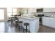Bright kitchen with white cabinets, stainless steel appliances, granite countertops, and an adjacent dining area at 259 Johnson Ridge Way, Four Oaks, NC 27524