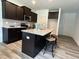 Modern kitchen featuring granite counters, a central island, and sleek dark cabinetry at 259 Johnson Ridge Way, Four Oaks, NC 27524