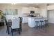 Open kitchen with white cabinets, stainless steel appliances, granite countertops, and an adjacent dining area at 259 Johnson Ridge Way, Four Oaks, NC 27524