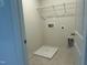Laundry room with gray tile floors and hookups for washer and dryer at 259 Johnson Ridge Way, Four Oaks, NC 27524