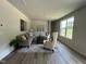 Bright living room features neutral decor, stylish furniture, and a large window at 259 Johnson Ridge Way, Four Oaks, NC 27524