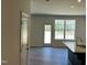 Bright and airy living room area with large windows and sleek laminate flooring at 259 Johnson Ridge Way, Four Oaks, NC 27524
