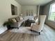 A comfortable living room furnished with a sofa, chairs, and a stylish rug at 259 Johnson Ridge Way, Four Oaks, NC 27524