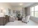 Cozy living room with ample natural light, neutral color scheme, comfortable seating and stylish decor at 259 Johnson Ridge Way, Four Oaks, NC 27524