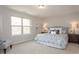 Serene main bedroom with large window, plush bedding, and stylish nightstands creating a calming retreat at 259 Johnson Ridge Way, Four Oaks, NC 27524