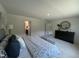 Large main bedroom includes a dresser and ensuite bathroom for convenience at 259 Johnson Ridge Way, Four Oaks, NC 27524