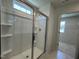 Modern shower stall in neutral colors with built in shelving and glass doors at 259 Johnson Ridge Way, Four Oaks, NC 27524