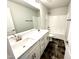 Modern bathroom with double vanity, tiled flooring, and shower-tub combination at 320 Bishop Ln, Sanford, NC 27330