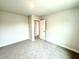 Carpeted bedroom with a glimpse into the adjoining hallway and ensuite bathroom at 320 Bishop Ln, Sanford, NC 27330