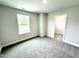 Bright bedroom with a window view and convenient access to a walk-in closet at 320 Bishop Ln, Sanford, NC 27330