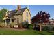 Charming exterior view of the historical Railroad House featuring well-manicured landscaping and lush greenery at 320 Bishop Ln, Sanford, NC 27330