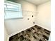 Practical laundry room featuring tiled flooring, window, and hookups at 320 Bishop Ln, Sanford, NC 27330