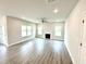 Bright living room with hardwood floors, fireplace, and large windows offering natural light at 320 Bishop Ln, Sanford, NC 27330