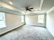 Spacious main bedroom with large windows, plush carpeting, and a modern ceiling fan for optimal comfort at 320 Bishop Ln, Sanford, NC 27330