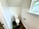 Stylish powder room featuring a modern toilet, sleek fixtures, and beautiful, dark tile flooring at 320 Bishop Ln, Sanford, NC 27330