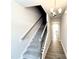 Carpeted staircase with modern railing, leading to upper floors of the home at 320 Bishop Ln, Sanford, NC 27330