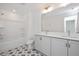 Shared bathroom with double vanity and patterned tile floor at 3939 Willow Gate Way, Knightdale, NC 27604