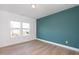 Bedroom with teal accent wall and hardwood floors at 3939 Willow Gate Way, Knightdale, NC 27604