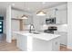 Modern kitchen with white cabinets, herringbone backsplash, and island at 3939 Willow Gate Way, Knightdale, NC 27604
