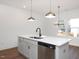 Kitchen island with sink, dishwasher, and quartz countertop at 3939 Willow Gate Way, Knightdale, NC 27604