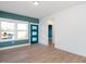 Room with teal accent wall, hardwood floors, and a modern door at 3939 Willow Gate Way, Knightdale, NC 27604