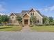 Charming two-story home with manicured lawn, stone walkway, and inviting double door entry at 548 Double N Rd, Pittsboro, NC 27312