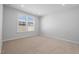 Bright bedroom featuring plush carpeting, neutral walls, and a window offering natural light at 1829 Hydrangea Way, Fuquay Varina, NC 27526