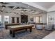 Spacious game room featuring pool tables, comfortable seating, and modern decor at 1829 Hydrangea Way, Fuquay Varina, NC 27526