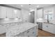 Bright kitchen featuring white cabinets, granite countertops, a stainless steel dishwasher, and pendant lights at 1829 Hydrangea Way, Fuquay Varina, NC 27526
