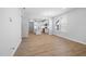 Open concept living space featuring vinyl flooring, a view of the kitchen, and natural light from the large windows at 1829 Hydrangea Way, Fuquay Varina, NC 27526