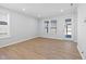 Inviting living room with durable flooring, neutral walls, and sliding glass door at 1829 Hydrangea Way, Fuquay Varina, NC 27526