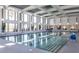 Bright indoor pool area with large windows and seating at 1829 Hydrangea Way, Fuquay Varina, NC 27526