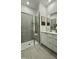 Modern bathroom with a large walk-in shower, double vanity, and gray tile at 2007 Opulent Oaks Ln # 24, Durham, NC 27713