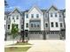 Modern townhome exterior features a two-car garage and a well-maintained lawn at 2007 Opulent Oaks Ln # 24, Durham, NC 27713
