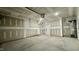 Unfinished garage with high ceilings and door at 2007 Opulent Oaks Ln # 24, Durham, NC 27713