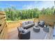 An outdoor patio with comfortable seating and views of the surrounding trees at 2007 Opulent Oaks Ln # 24, Durham, NC 27713