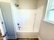 Bright bathroom featuring a crisp white shower-tub combo and bronze fixtures at 214 Drayton Hall Ln, Sanford, NC 27330