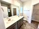 Bright bathroom with double sink vanity, large mirror, and ceramic tile flooring at 214 Drayton Hall Ln, Sanford, NC 27330