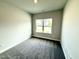 Comfortable bedroom with a large window showcasing a green front yard at 214 Drayton Hall Ln, Sanford, NC 27330