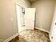 Light and airy entryway with vinyl flooring and white trim; cabinet visible through doorway at 214 Drayton Hall Ln, Sanford, NC 27330