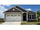 Beautiful home featuring a stone facade and a white garage door with decorative hardware at 214 Drayton Hall Ln, Sanford, NC 27330