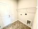 A well-organized laundry room with tile flooring, utility connections and a wire shelf at 214 Drayton Hall Ln, Sanford, NC 27330