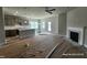 Open concept living room with fireplace, kitchen and island with pendant lighting at 214 Drayton Hall Ln, Sanford, NC 27330