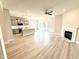 Open living space boasts a fireplace, flowing into a modern kitchen with an island and stainless appliances at 214 Drayton Hall Ln, Sanford, NC 27330