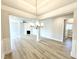 Open concept living spaces with a fireplace, light-colored walls, and light-colored hardwood flooring at 214 Drayton Hall Ln, Sanford, NC 27330