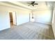 Large main bedroom boasts neutral walls, plush carpet, and open access to the walk-in closet at 214 Drayton Hall Ln, Sanford, NC 27330