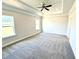 Expansive main bedroom features trey ceiling, ceiling fan, and two large windows at 214 Drayton Hall Ln, Sanford, NC 27330