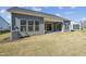 Home exterior with lush backyard, patio, and grey siding at 2209 Abbeyhill Dr # 118, Raleigh, NC 27610